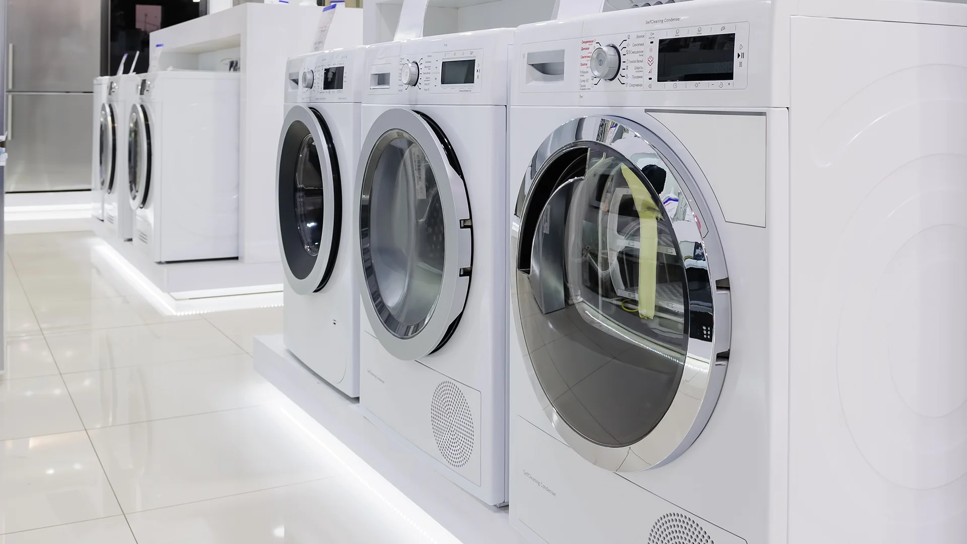 Front-load washers and dryers with tempered glass doors