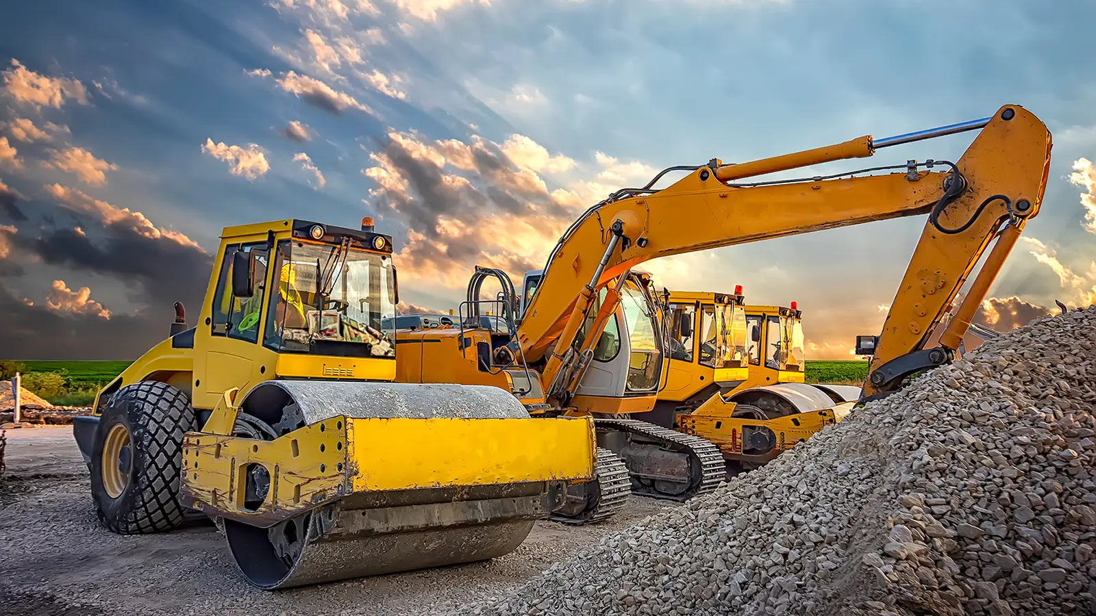 Road rollers and excavators with cab glass on a construction site